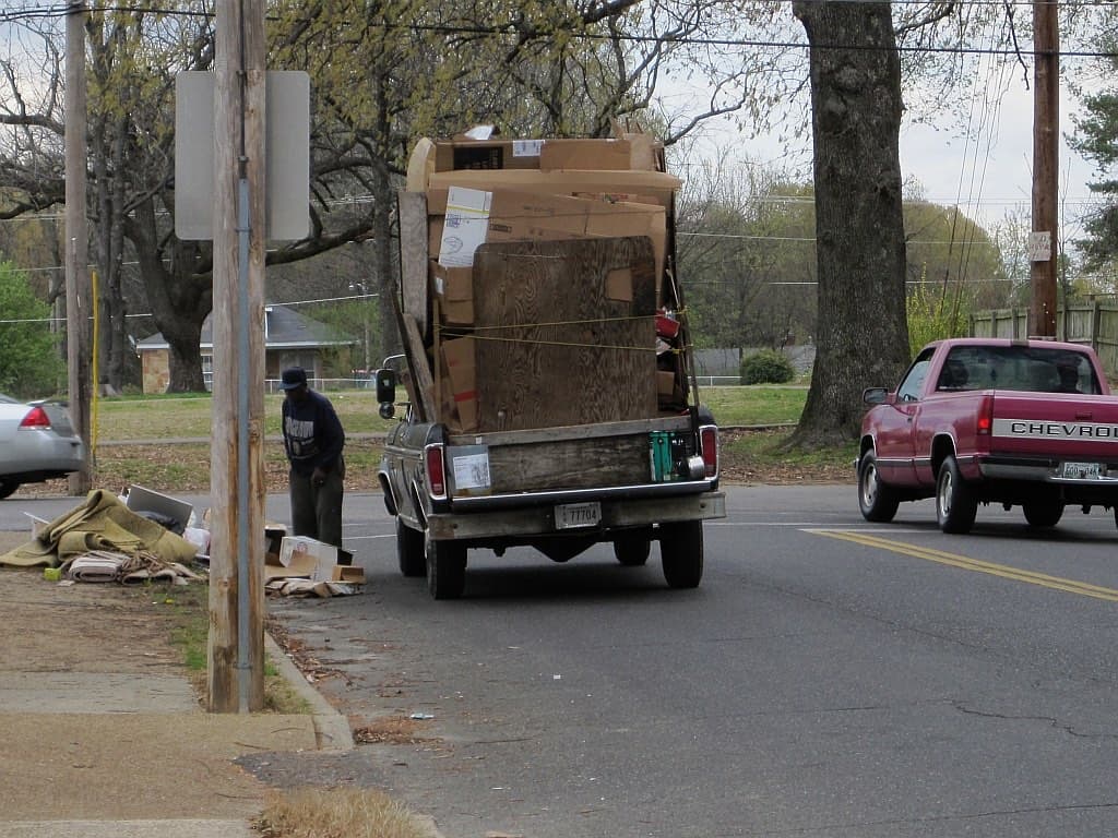 Pickup truck bed loaded with junk and old furniture